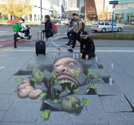 В Польше появилось граффити с Зеленским, который пожирает евро и доллары, затягивая страну в чёрную дыру.png